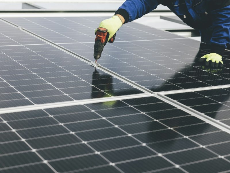 Technician working on a solar panel array